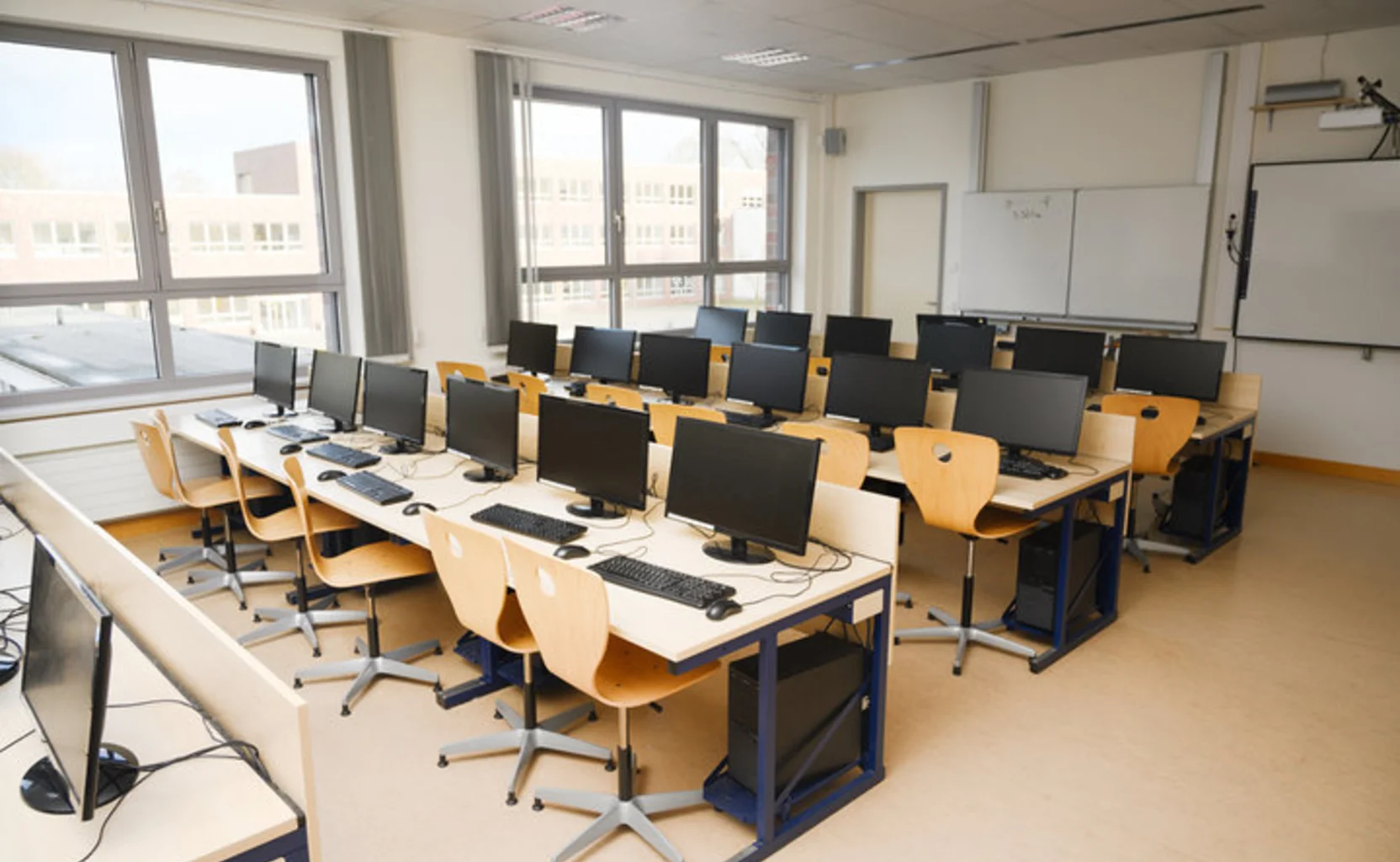School computer lab with workstations and whiteboard